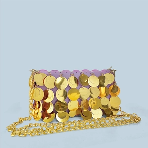 Detail of purple sequin bag with large gold metallic discs and chunky chain strap