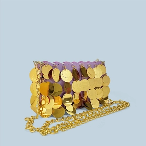 Close-up of golden sequins on purple mini chain bag for evening and party styles