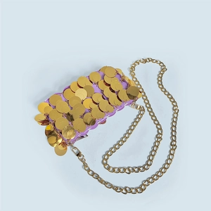 Macro shot of purple evening bag with gold sequins and a delicate chain strap