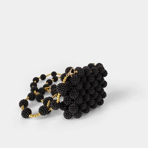 Detailed view of handmade black beaded evening bag with textured pearls and gold lobster clasp