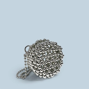 Detail of silver beaded sphere bag with polished finish and hollow woven design