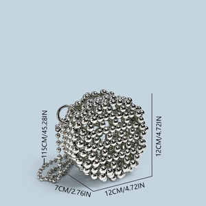 Macro shot showing dimensions of a spherical silver beaded bag with a metal chain strap