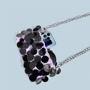 Detail view of sequined crossbody bag showing capacity for a smartphone and mirror