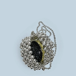 Detail of silver beaded sphere bag with black polished center and matching chain