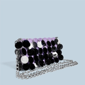Detailed macro view of purple sequin bag with silver chain and metallic scales
