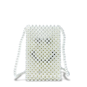 Detailed view of handmade white pearl woven crossbody bag with beaded shoulder strap