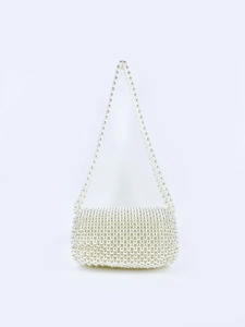 Detail of handcrafted pearl beaded flap handbag with smooth round artificial pearls