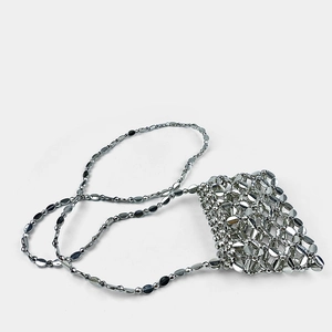 Detail of silver metallic paillette chain bag showing intricate mesh construction