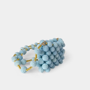 Detail of light blue beaded handbag with matte texture and golden lobster clasp