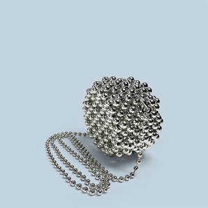Detail of silver spherical beaded evening bag with reflective metallic surface and chain
