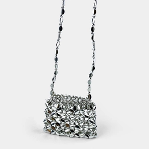 Detail of silver metallic woven mini bag featuring oval linked plates and thin chain strap