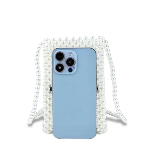Detailed shot of white pearl woven crossbody bag with phone inside for size comparison