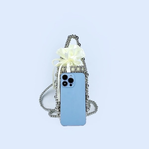 Detail of silver beaded mini handbag with white satin drawstring pouch and long bead chain