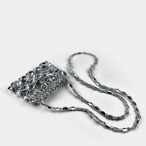 Detail of silver metallic sequin mini bag showing the handcrafted woven link texture