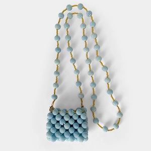 Detailed view of light blue handmade beaded mini bag with elegant gold accents