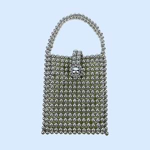 Detailed view of handmade silver beaded square handbag with flower clasp and mini beads