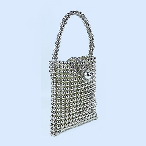 Detail of handmade silver beaded handbag with metallic beads and spherical clasp