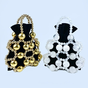 Detail of beaded bucket bag with gold metal beads and black velvet drawstring liner