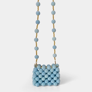 Detailed view of handmade light blue beaded mini bag with elegant gold bead accents