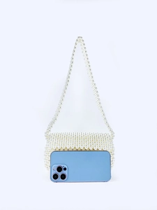 Detail of handmade cream white pearl woven tote bag with a smartphone for size reference