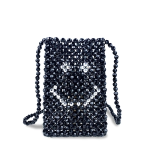 Detail of handmade black beaded crossbody bag with white smiling face pattern
