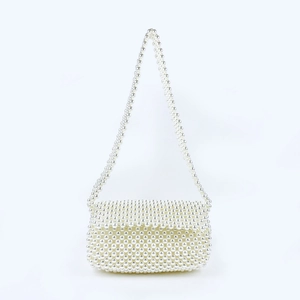 Detailed view of handcrafted white pearl beads and elegant weaving on the small tote bag