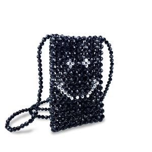 Close-up of handmade black beaded crossbody bag with a cute silver beaded smiley face