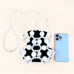 Detailed top view of a beaded bucket bag with white frosted beads and black inner pouch