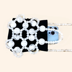 Detail of beaded bucket bag with white translucent beads and black velvet inner pouch