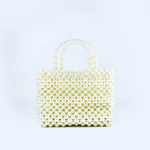 Close-up detail of handcrafted rectangle pearl beaded handbag with woven satin finish