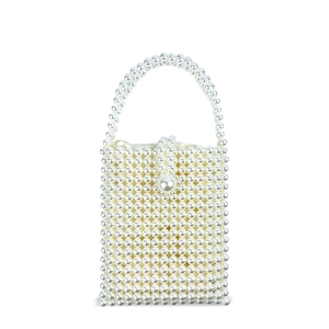 Close-up of handmade white pearl beaded handbag with satin lining and square flap cover
