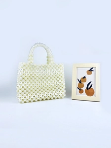 Handmade cream pearl woven handbag with a structured square design and elegant top handle