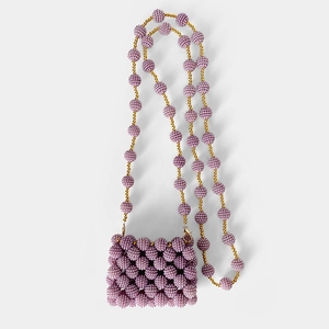 Detailed view of purple handcrafted beaded mini bag with textured spheres and gold chain