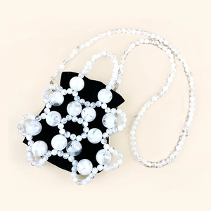 Detail view of woven beaded bucket bag with white textured beads and black velvet liner