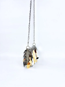 Detailed view of bicolor gold and silver sequin chain bag with metallic fish scale texture