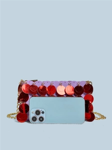Handmade purple sequin crossbody bag with gold chain shown next to a smartphone for scale