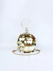 Close-up of golden sequin sphere bag with metallic ring handle and chain strap
