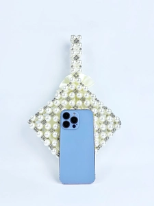 Detail of handmade pearl bead handbag with phone to show actual size and diamond shape