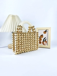 Elegant handmade pearl beaded handbag in gold and white for evening luxury occasions