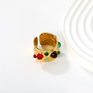 Detail of vintage 18K gold plated wide ring with colorful stones and inner texture
