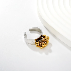 Detail of 18K gold plated ring featuring hammered texture and cluster bead tassels