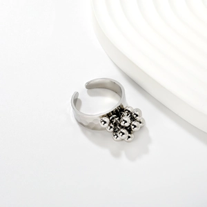 Macro view of hammered silver ring with clustered bead fringe and 18K gold open band