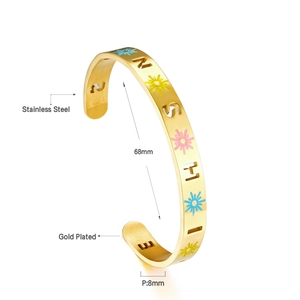 Détail macro du bracelet manchette en acier plaqué or avec motif SUNSHINE ajouré