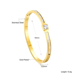 Detail of 18K gold plated stainless steel cuff with shell inlay and cubic zirconia
