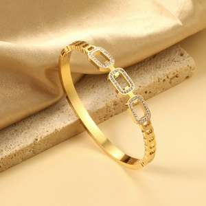 Detail of 18K gold plated stainless steel bangle with pavé rectangular links