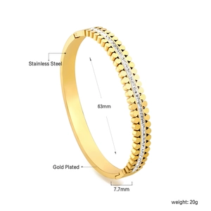 Detail of 18K gold plated stainless steel geometric bangle with inlaid sparkling crystals