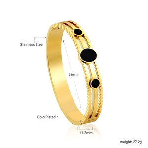 Detail of 18K gold plated stainless steel bangle with 63mm inner diameter and black studs