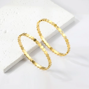 Macro shot of 18K gold plated hexagonal honeycomb bracelets with sparkling crystal detail