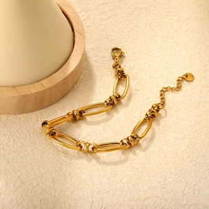 Minimalist gold link chain bracelet with twisted connectors and adjustable lobster clasp