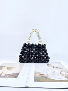 Handgefertigte schwarze Perltasche mit kontrastierendem cremeweißem Perlengriff